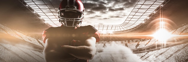 American football player standing with arms crossed