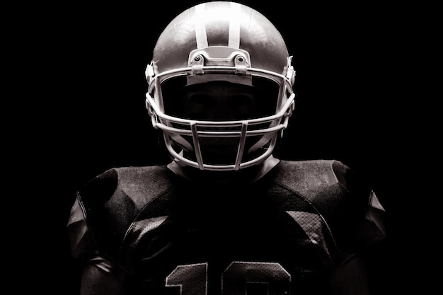 American football player standing with rugby helmet