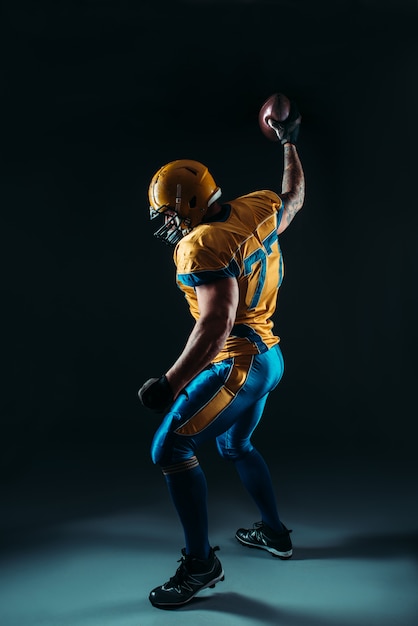 Photo american football player with ball in hand, nfl