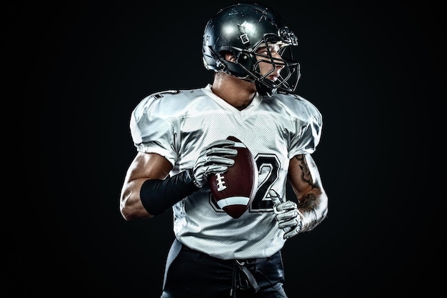 American football sportsman player in helmet on black background Sport and motivation Team sports