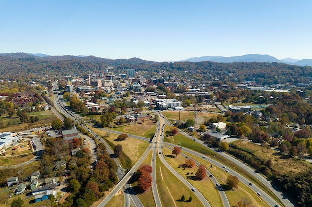 American freeway intersection in Asheville North Carolina with fast driving cars and trucks in autumnal season View from above of USA transportation infrastructure