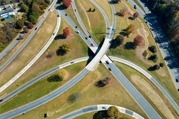 American freeway intersection with fast driving cars and trucks View from above of USA transportation infrastructure