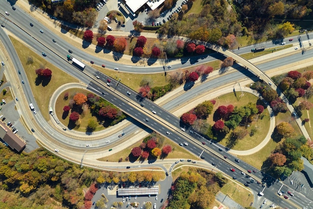 빠르게 운전하는 자동차와 트럭이 있는 미국 고속도로 교차로 미국 교통 인프라 위에서 보기