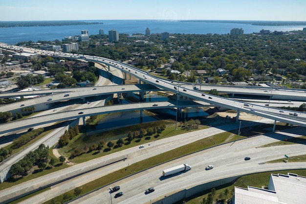 American freeway intersection with fast driving cars and trucks View from above of USA transportation infrastructure