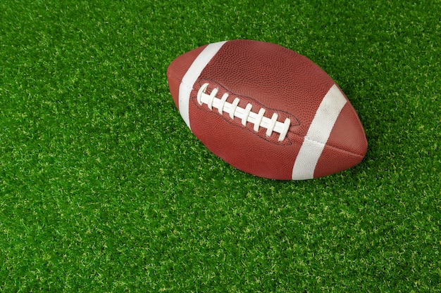 American game rugby ball on grass close up