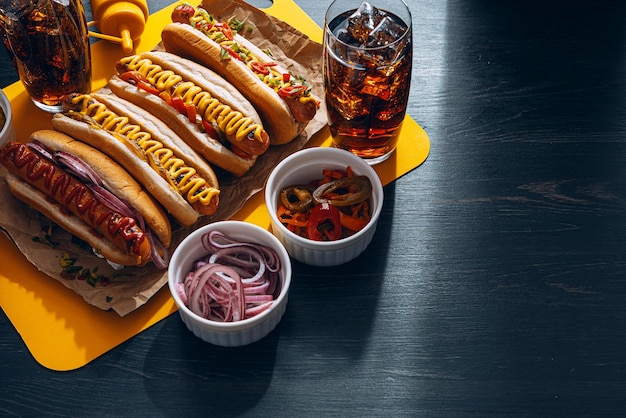 American hot dog with ingredients on a dark wooden background