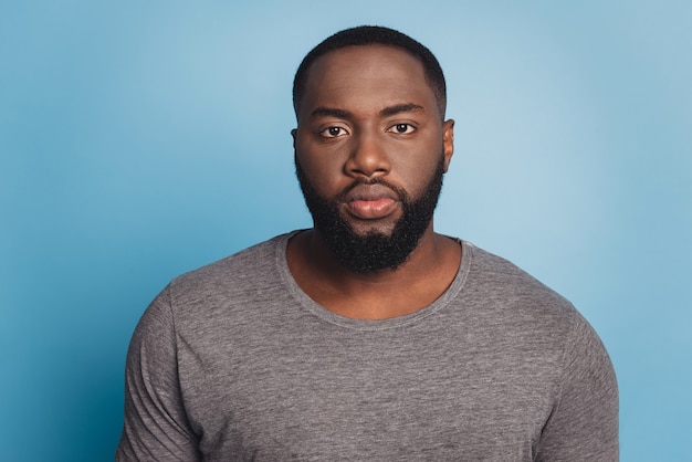 American male in t-shirt on blue isolated background