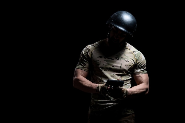 American marine corps special operations modern warfare soldier\
with helmet fire arm weapon ready for battle on black\
background