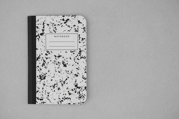 American notebook on grey background