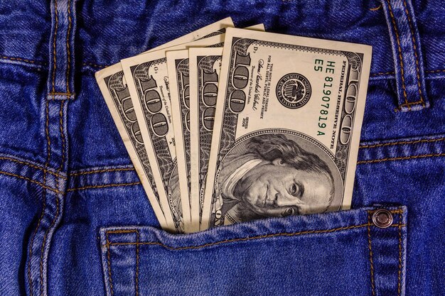 American one hundred dollar banknotes in a pocket of blue jeans