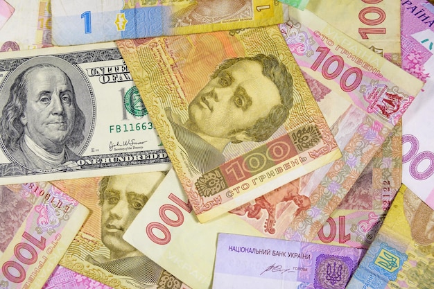 American one hundred dollars banknote on the many ukrainian hryvnas