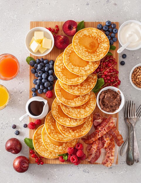 American pancake board with bacon berries maple syrup butter