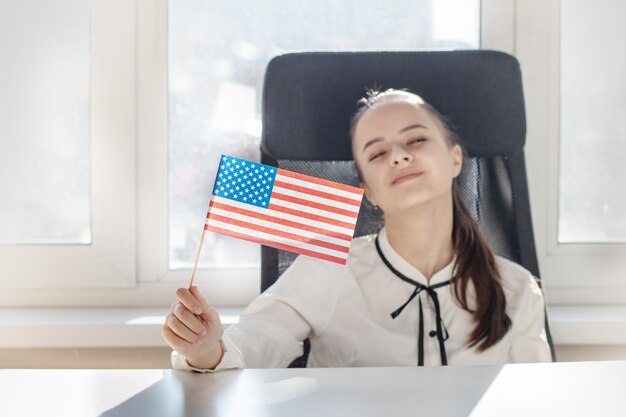 American patriot girl waving USA flag