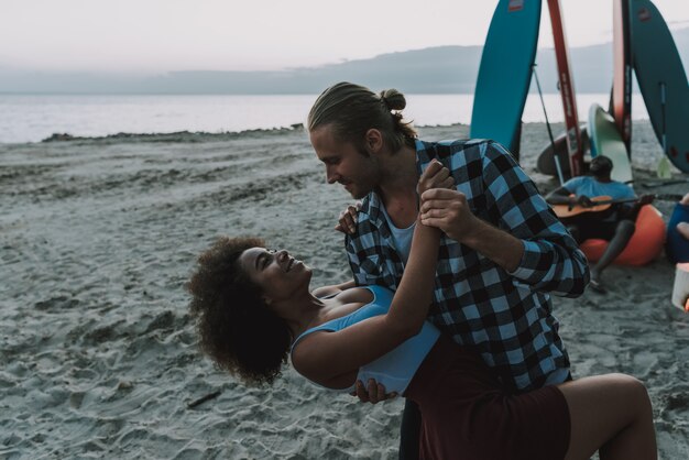 American people are dancing on beach.