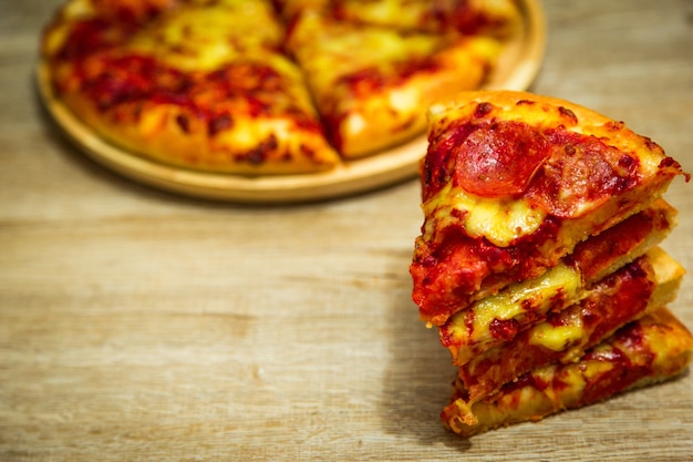 American pizza with pepperoni on a wooden table