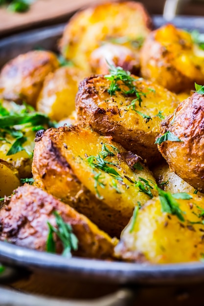 American roasted potatoes with smoked bacon garlic salt pepper cumin dill parsley  herb decoration