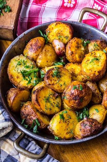 American roasted potatoes with smoked bacon garlic salt pepper cumin dill parsley  herb decoration