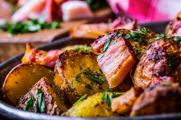 American roasted potatoes with smoked bacon garlic salt pepper cumin dill parsley  herb decoration