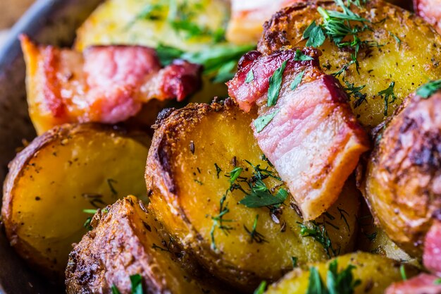 American roasted potatoes with smoked bacon garlic salt pepper cumin dill parsley  herb decoration