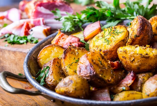 American roasted potatoes with smoked bacon garlic salt pepper cumin dill parsley  herb decoration