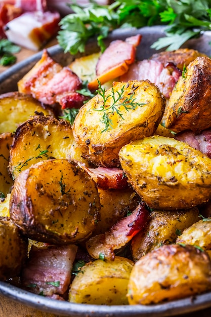 American roasted potatoes with smoked bacon garlic salt pepper cumin dill parsley  herb decoration