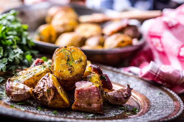 American roasted potatoes with smoked bacon garlic salt pepper cumin dill parsley  herb decoration