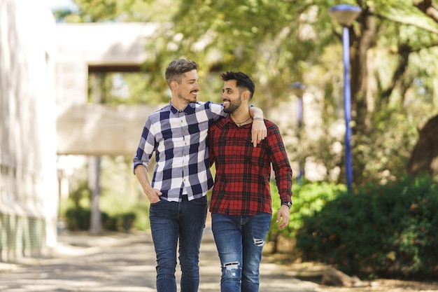 American shot of a gay couple walking around hugging and looking at each other