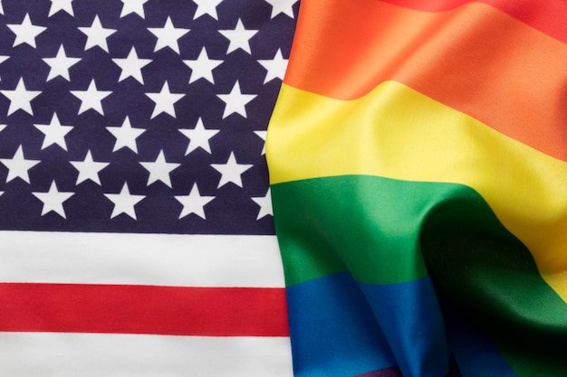 Photo american stars and stripes flag alongside a gay pride lgbt rainbow flag