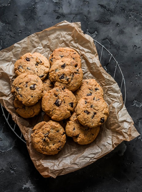 American style crispy cookies with chocolate drops on a dark background top view