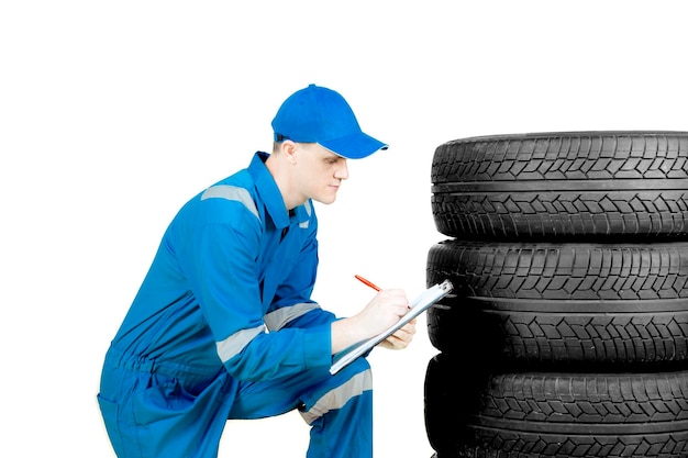 American technician examining tires on studio