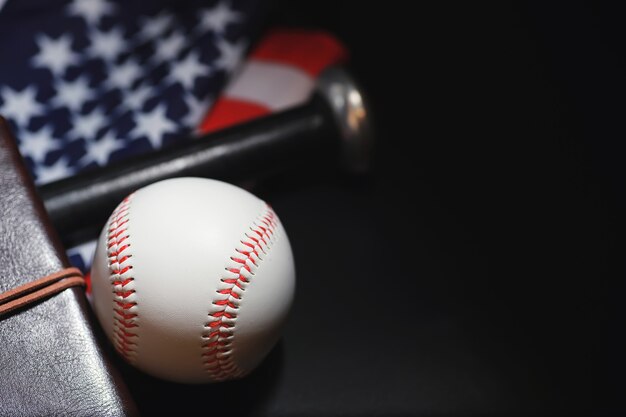 American traditional sports game. baseball. concept. baseball\
ball and bats on a table with american flag.