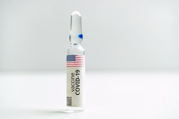 American USA developments of a coronavirus covid-19 vaccine in a glass ampoule.