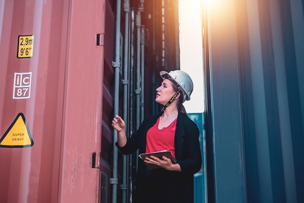 American women Work in an international shipping yard area Export and import delivery service with containers