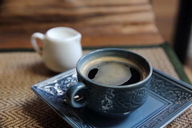 Americano coffee in wood background