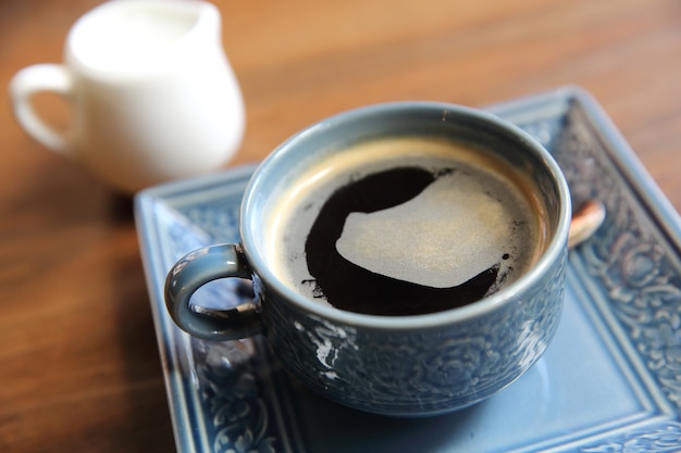 Americano coffee in wood background