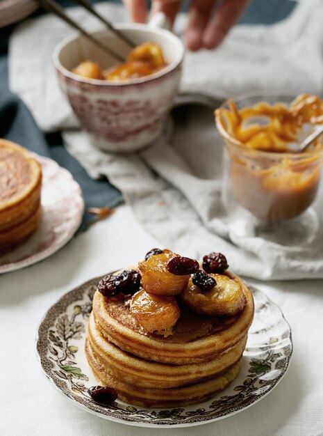 Amerikaans ontbijt, brunch, lunch, maaltijdpannekoeken met pindakaas en bananen over een wit servet. veganistisch eten concept