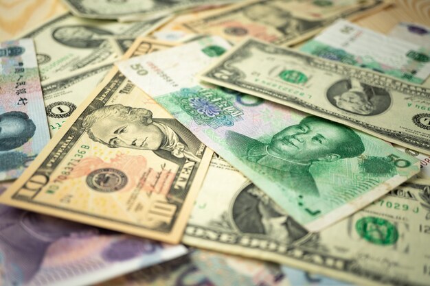 Amerikaanse dollarstapel en Chinese yuan bankbiljetten op de lijst