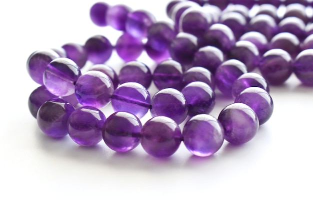 Amethyst bead strands on white table