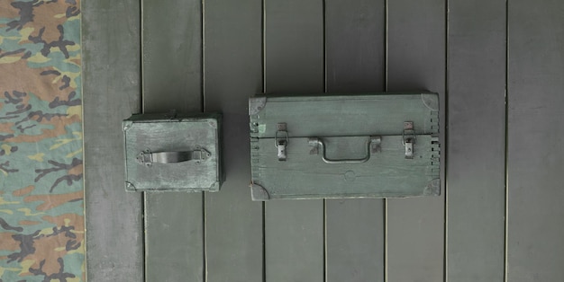 ammunition boxes on green wooden background