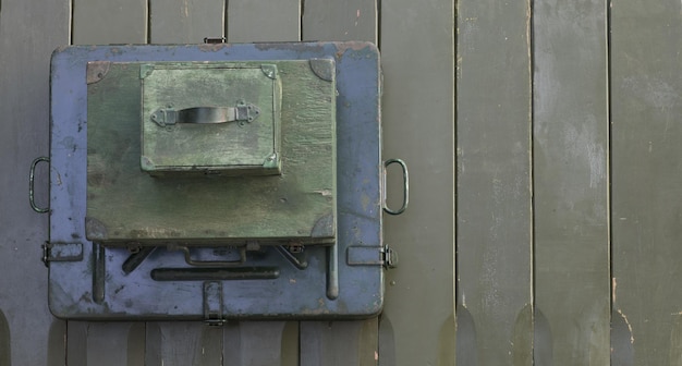 ammunition boxes on green wooden background