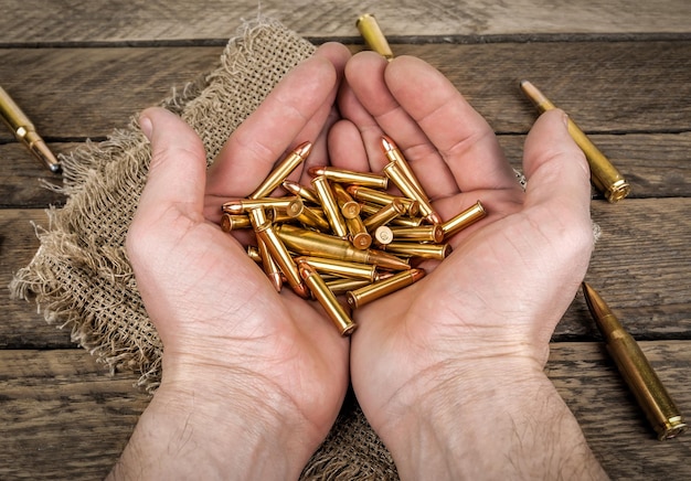 Ammunition of various calibers in the human palms