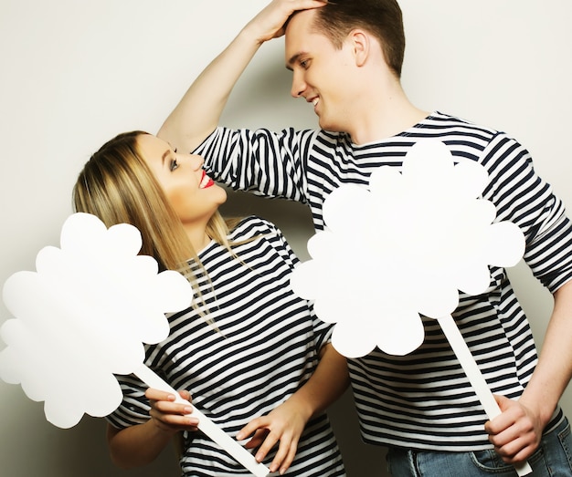 Amorous couple holding blank paper on stick