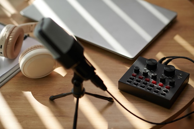 Усилитель микрофона и ноутбук на столе блоггера или подкастера