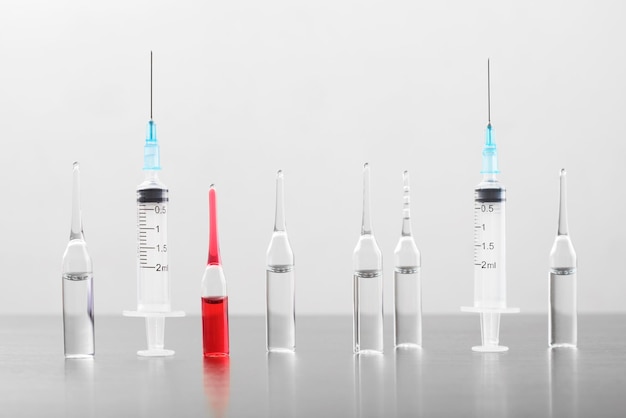 Ampoules and syringes standing in a row