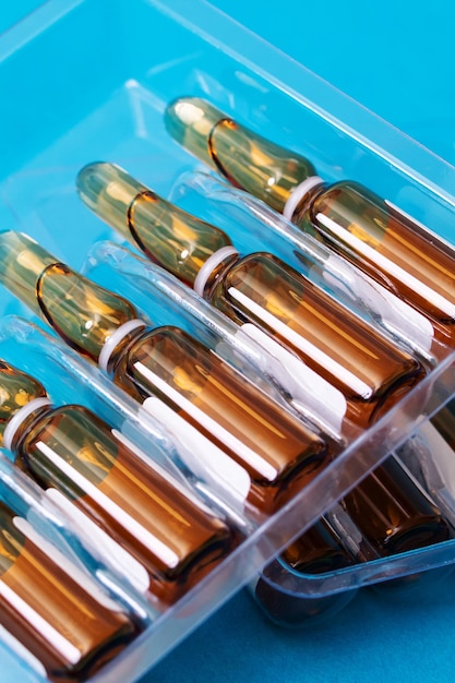 Ampoules with medicine on a blue background