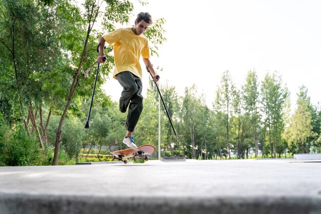 Amputated skater spending time at the skatepark. concept about disability and sports