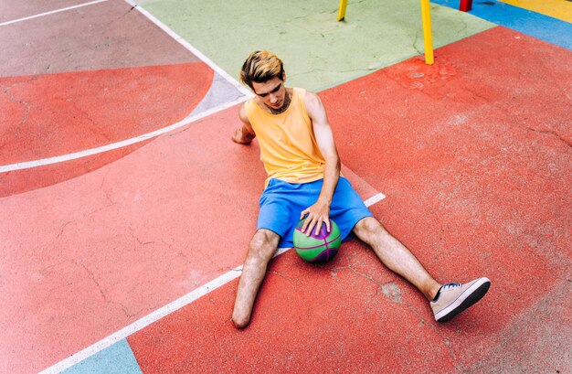 Amputated young boy playing basketball at the park and making sport. Concept about disabilities and persistence