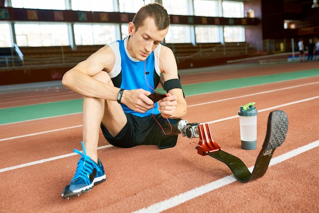 Amputee Sportsman Sitting on Floor