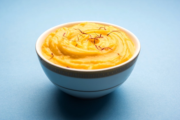 amrakhand or mango shrikhand or srikhand is popular indian dessert served with saffron toppings in a bowl