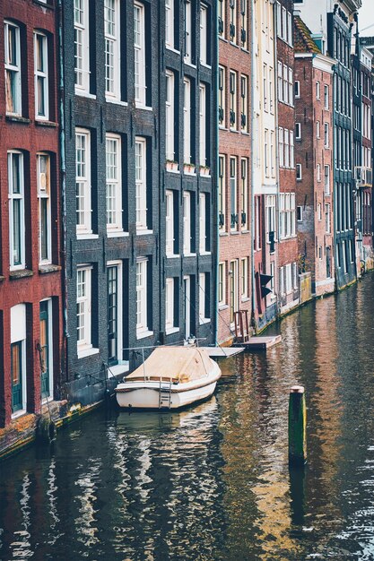 Amsterdam canal Damrak with houses Netherlands